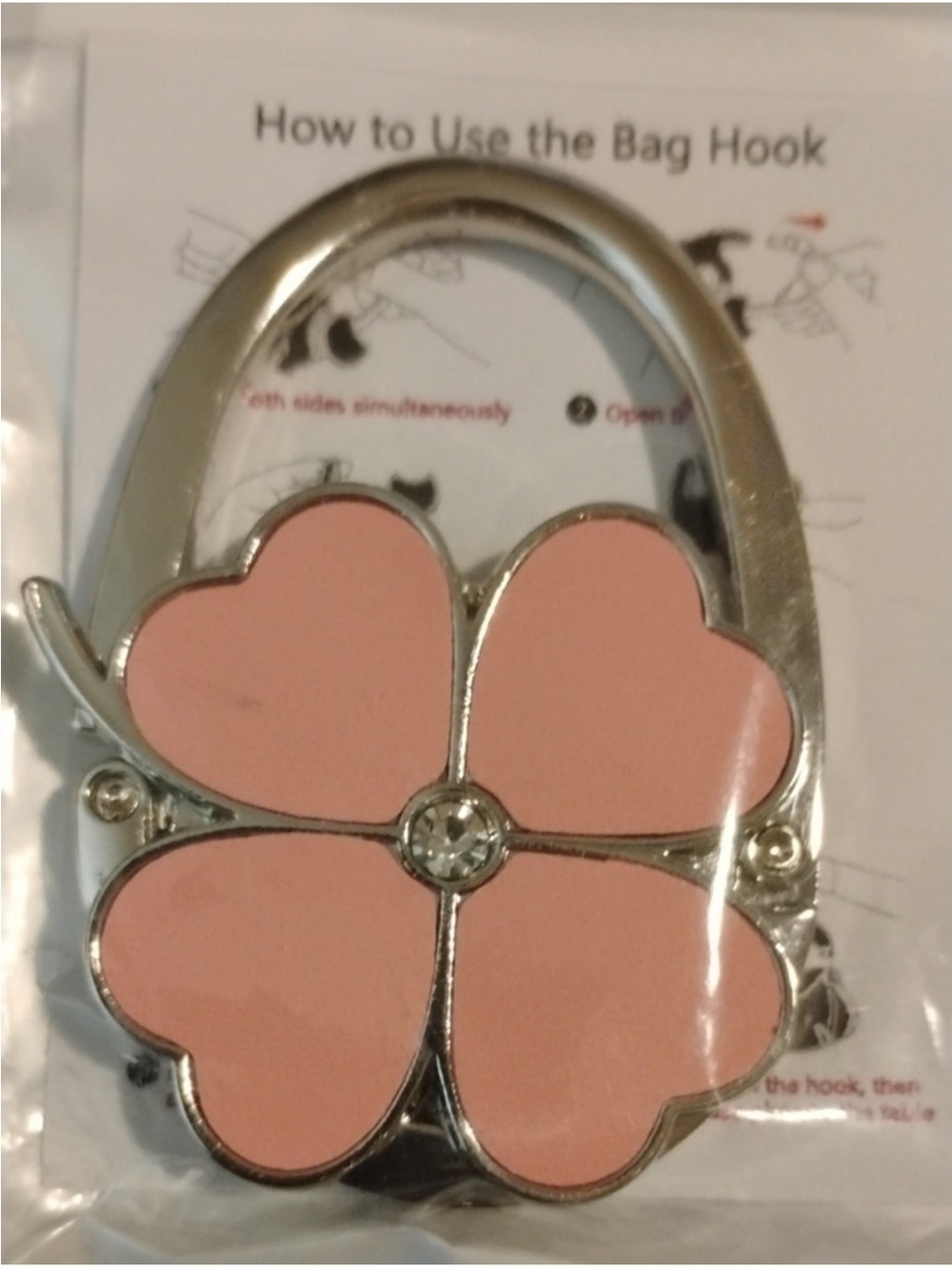 ROFLYER foldable purse hook with a pink four-leaf clover design.